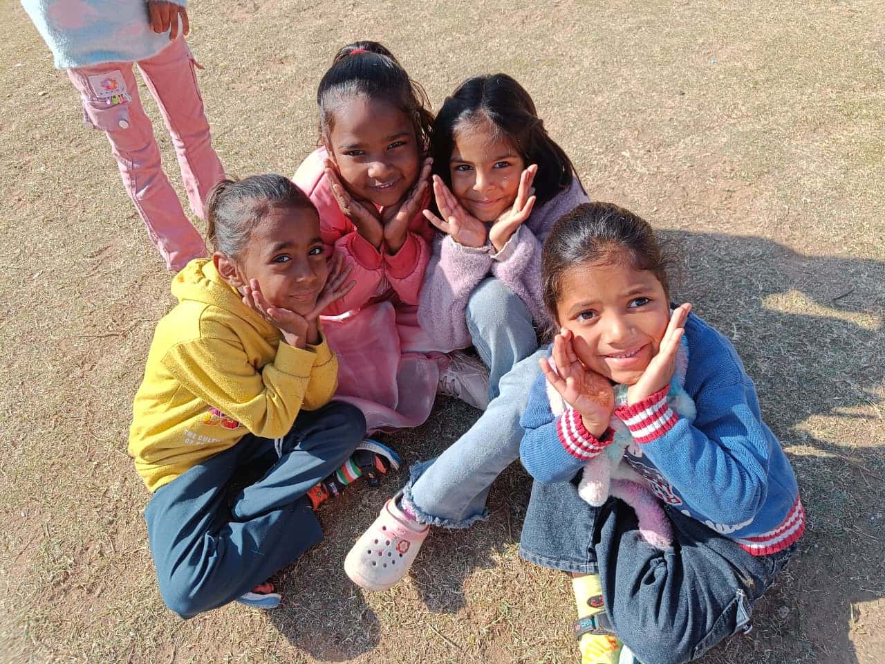 Four girls posing for the camera with cheerful expressions