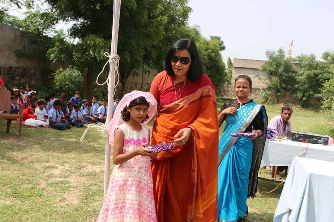 Founder with a young student at BSPS school ceremony