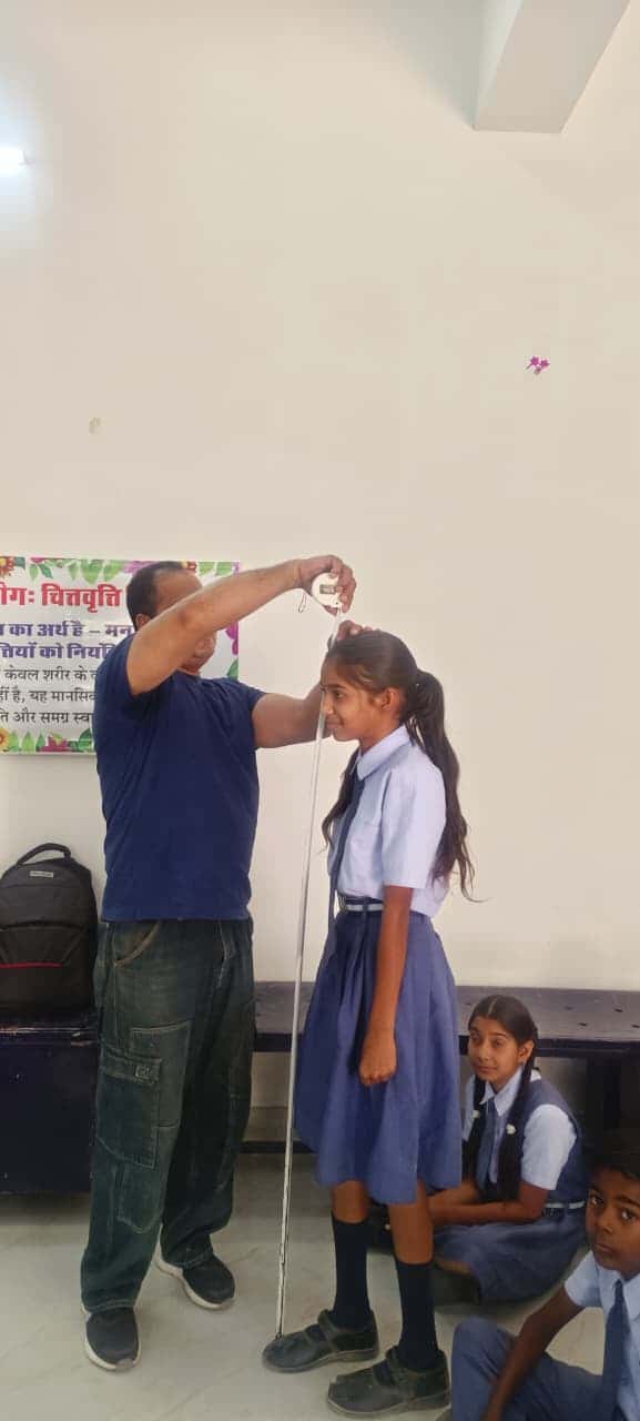 Height measurement during the screening — every student was measured