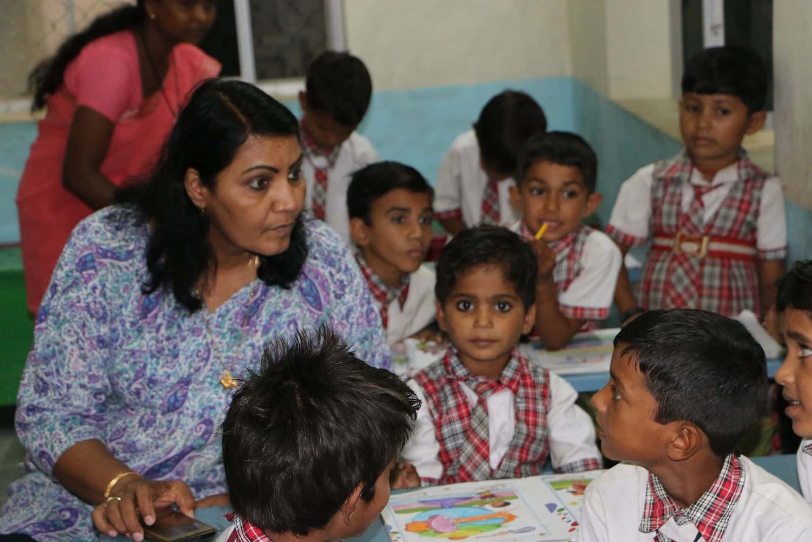 Teacher with young learners during an art and reading session