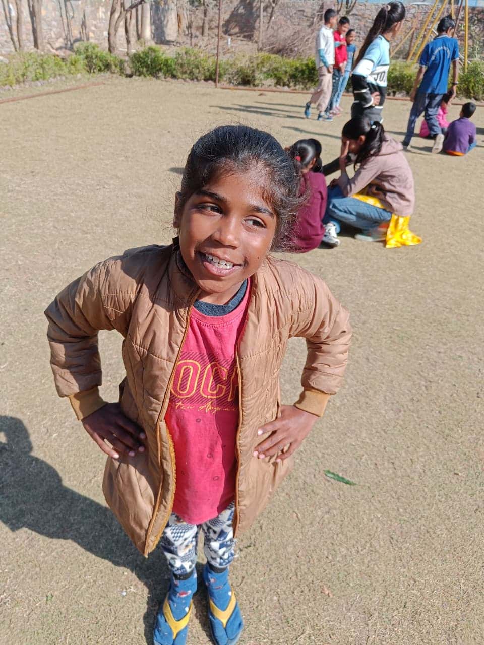 Confident girl student striking a pose on the playground