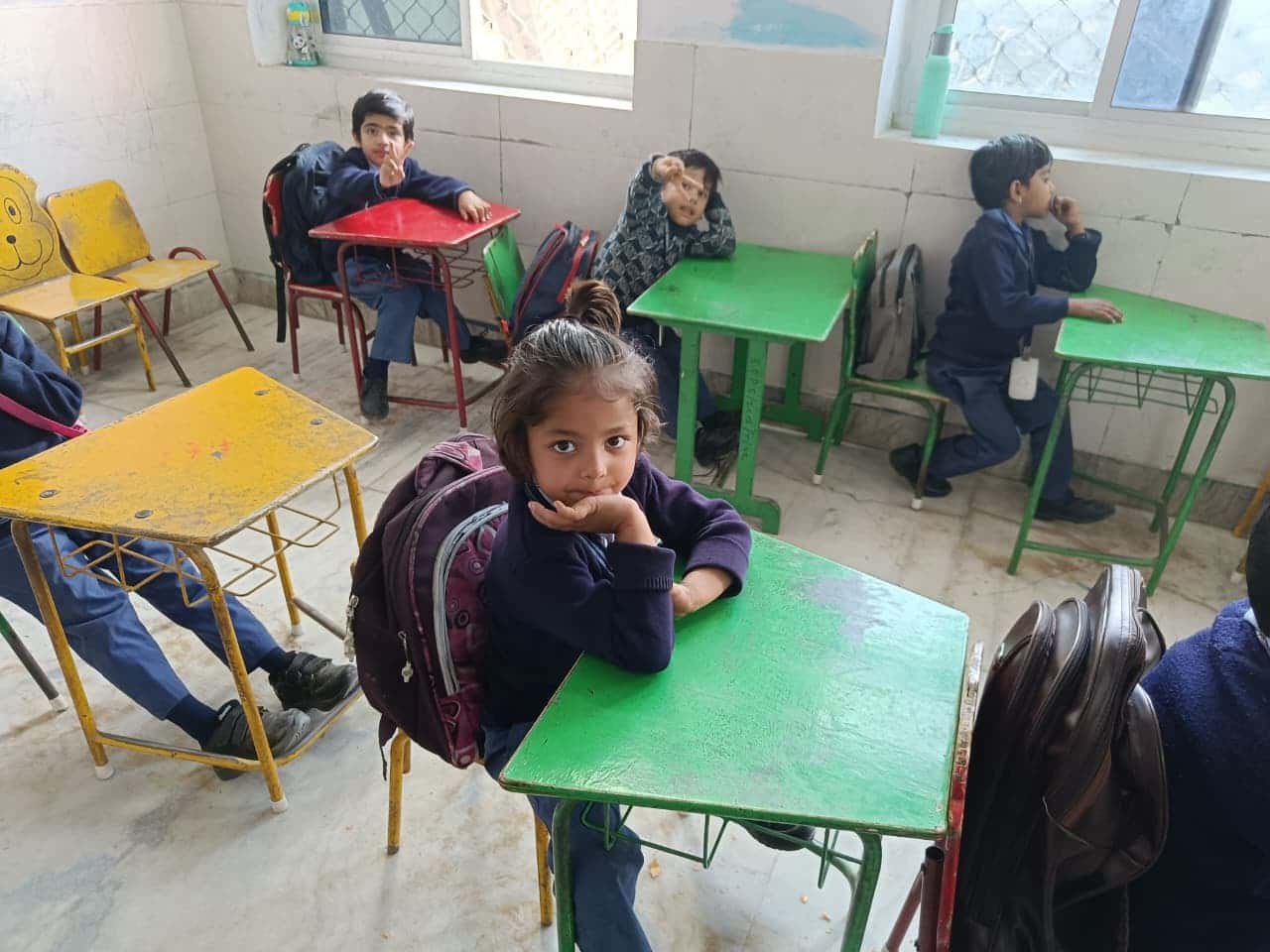 Young student looking up from her desk in a BSPS classroom